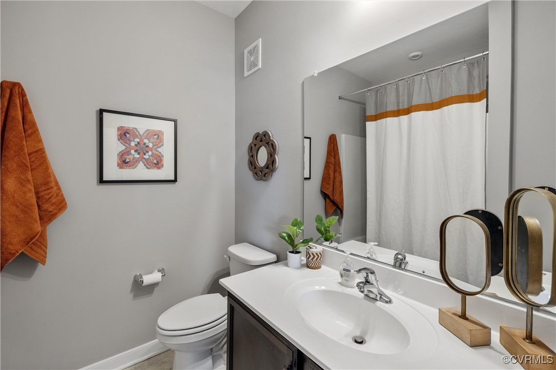 4112 Ebbies Crossing Midlothian, VA 23112 - Photo 17 of 38 a bathroom with a sink vanity mirror and toilet