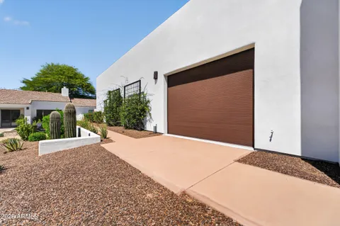a front view of a house with a yard and a garage