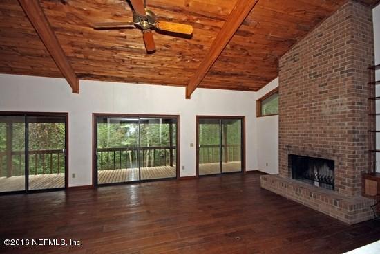 1209 Wedgewood Road St. Johns, FL 32259 - Photo 10 of 16 a view of an empty room with wooden floor and a fireplace