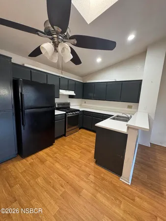 a kitchen with granite countertop a stove and a sink