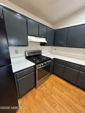 a kitchen with stainless steel appliances a stove and a refrigerator
