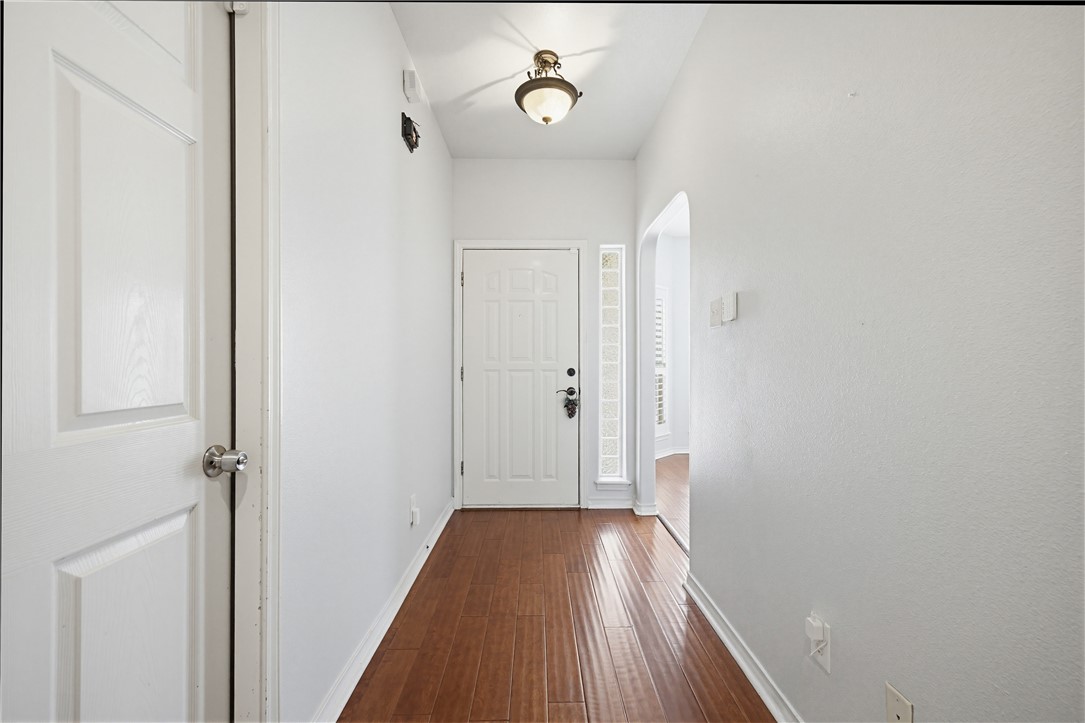 7251 Prairie Drive, Unit 6 Corpus Christi, TX 78413 - Photo 4 of 28 a view of a hallway with wooden floor and a ceiling fan