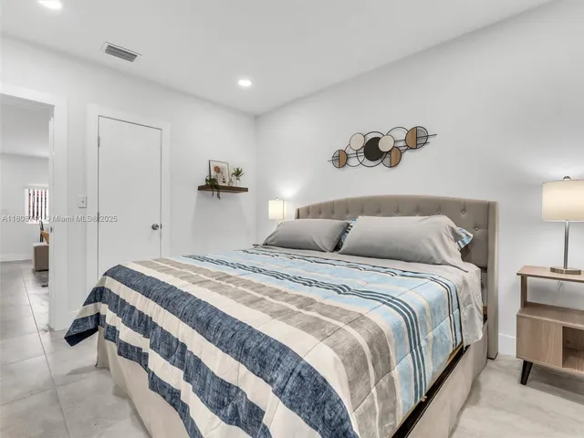 a bedroom with a bed and a lamp