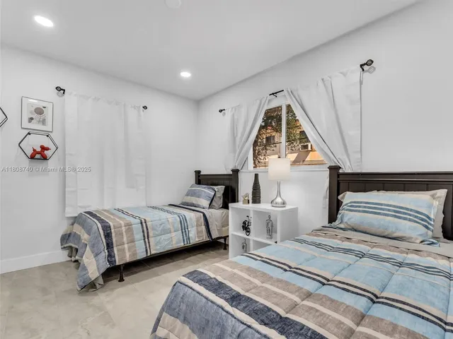 a bedroom with bed and a window