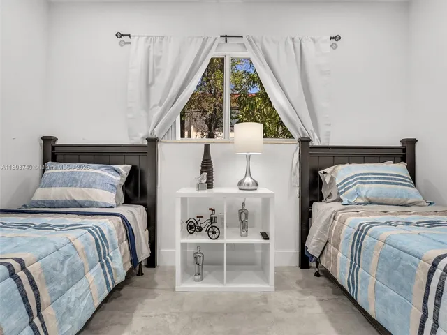 a bedroom with a bed and a large window