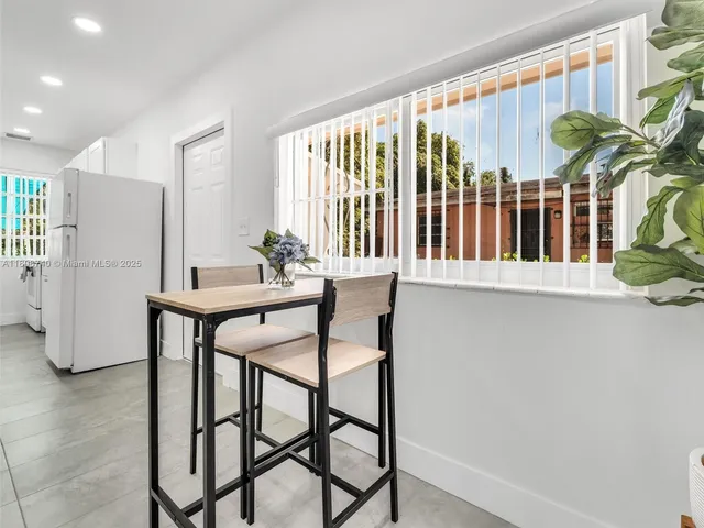 a view of a dining room with furniture and a window