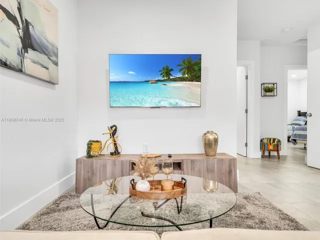 a living room with table and chairs
