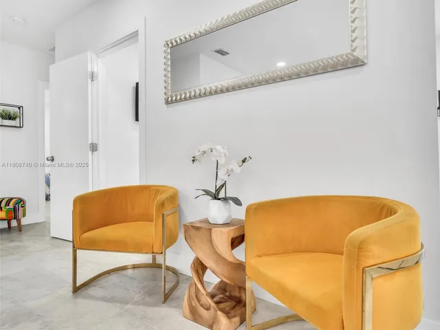 a bathroom with a tub and a chair