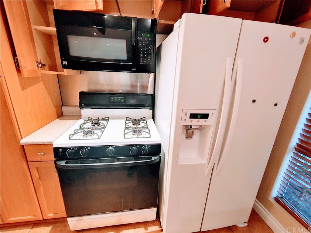 2811 South Fairview Street Santa Ana, CA 92704 - Photo 7 of 24 Wood cabinets in kitchen Refrigerator 2017, microwave 2015, range, dishwasher not shown replaced 2016.