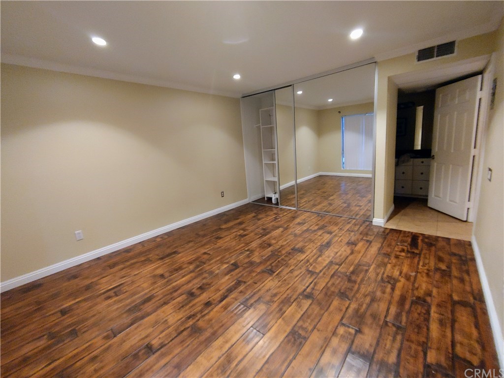 2811 South Fairview Street Santa Ana, CA 92704 - Photo 9 of 24 Large bedroom, real hardwood floors, mirrored closets with closet organizer, recessed lighting, newer six
paneled door.