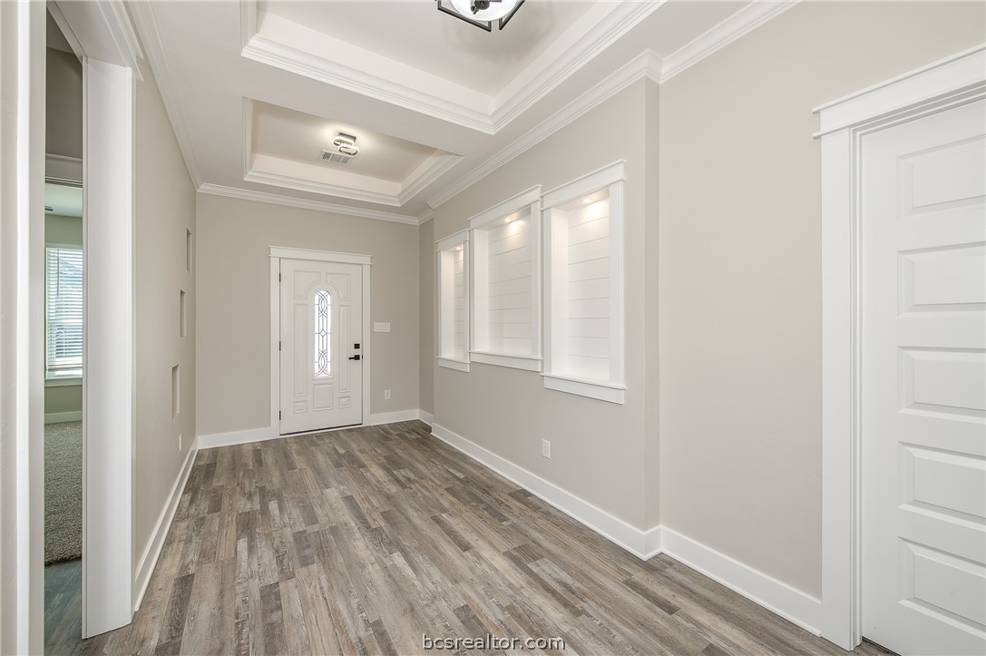 2908 GOLDBERG Drive Bryan, TX 77808 - Photo 6 of 44 View of the front door, decorative art niches, pop up ceilings and vinyl flooring.