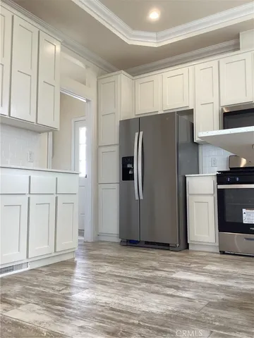 a view of a kitchen with refrigerator and cabinet