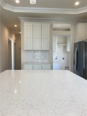 a view of kitchen and refrigerator