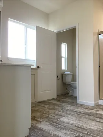a kitchen with a sink cabinets and wooden floor