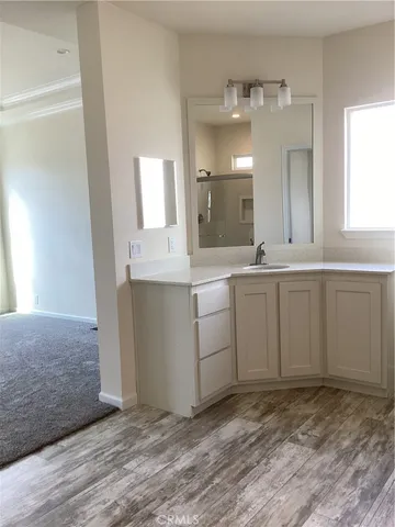 an empty room with cabinet and mirrors