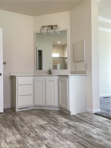 a large bathroom with a sink and a mirror