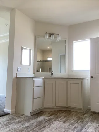 a view of a room with an empty space and wooden floor