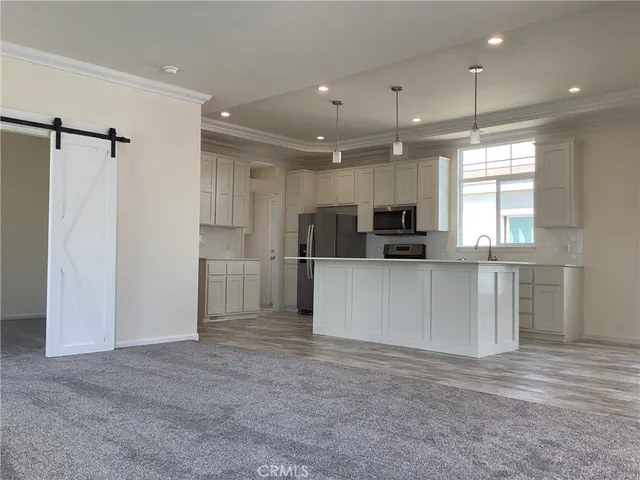 a view of kitchen with refrigerator and window