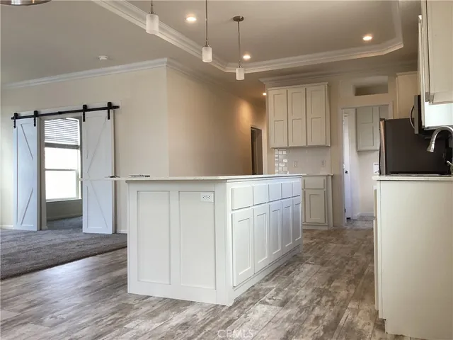 a kitchen with white cabinets and white appliances