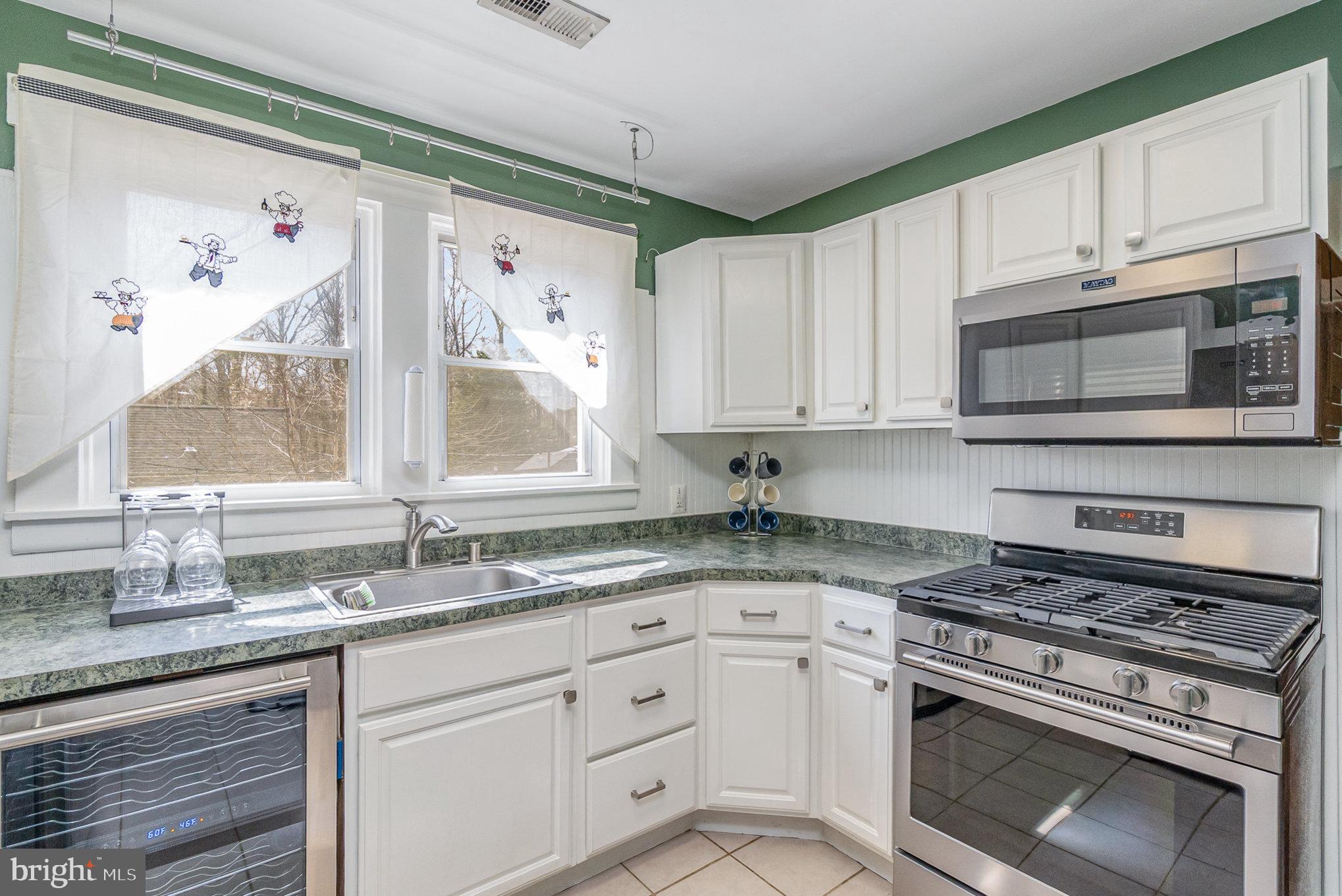 5813 Ebenezer Road White Marsh, MD 21162 - Photo 15 of 46 a kitchen with stainless steel appliances granite countertop a sink a stove and cabinets