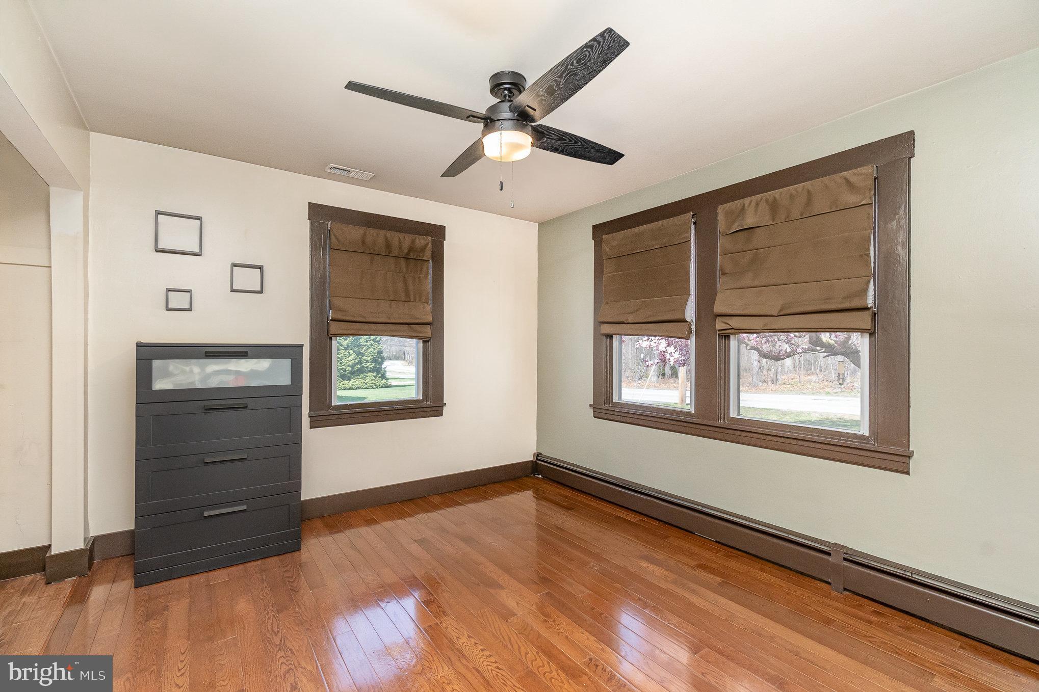 5813 Ebenezer Road White Marsh, MD 21162 - Photo 17 of 46 a view of an empty room with a window and wooden floor