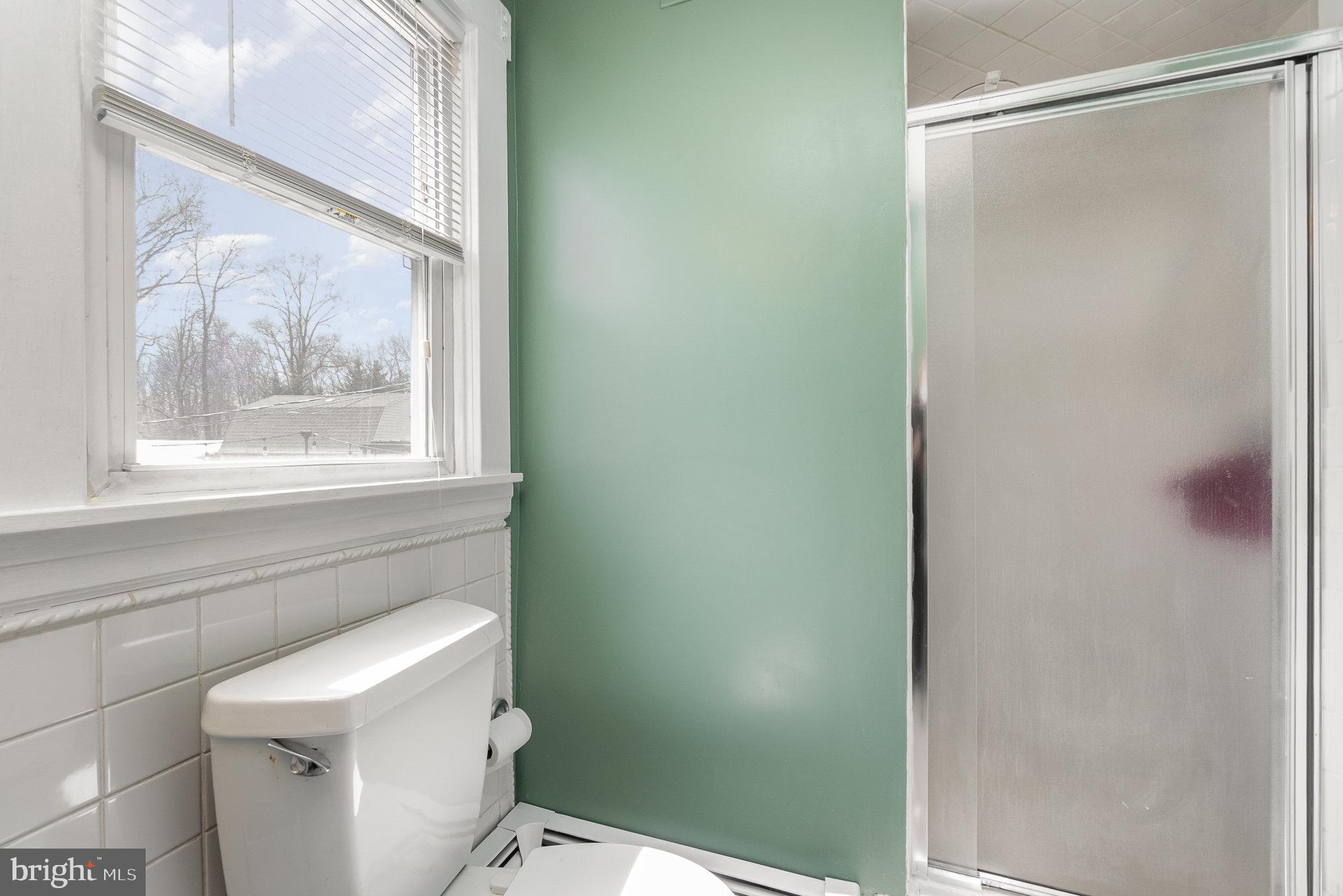 5813 Ebenezer Road White Marsh, MD 21162 - Photo 19 of 46 a bathroom with a window and a shower
