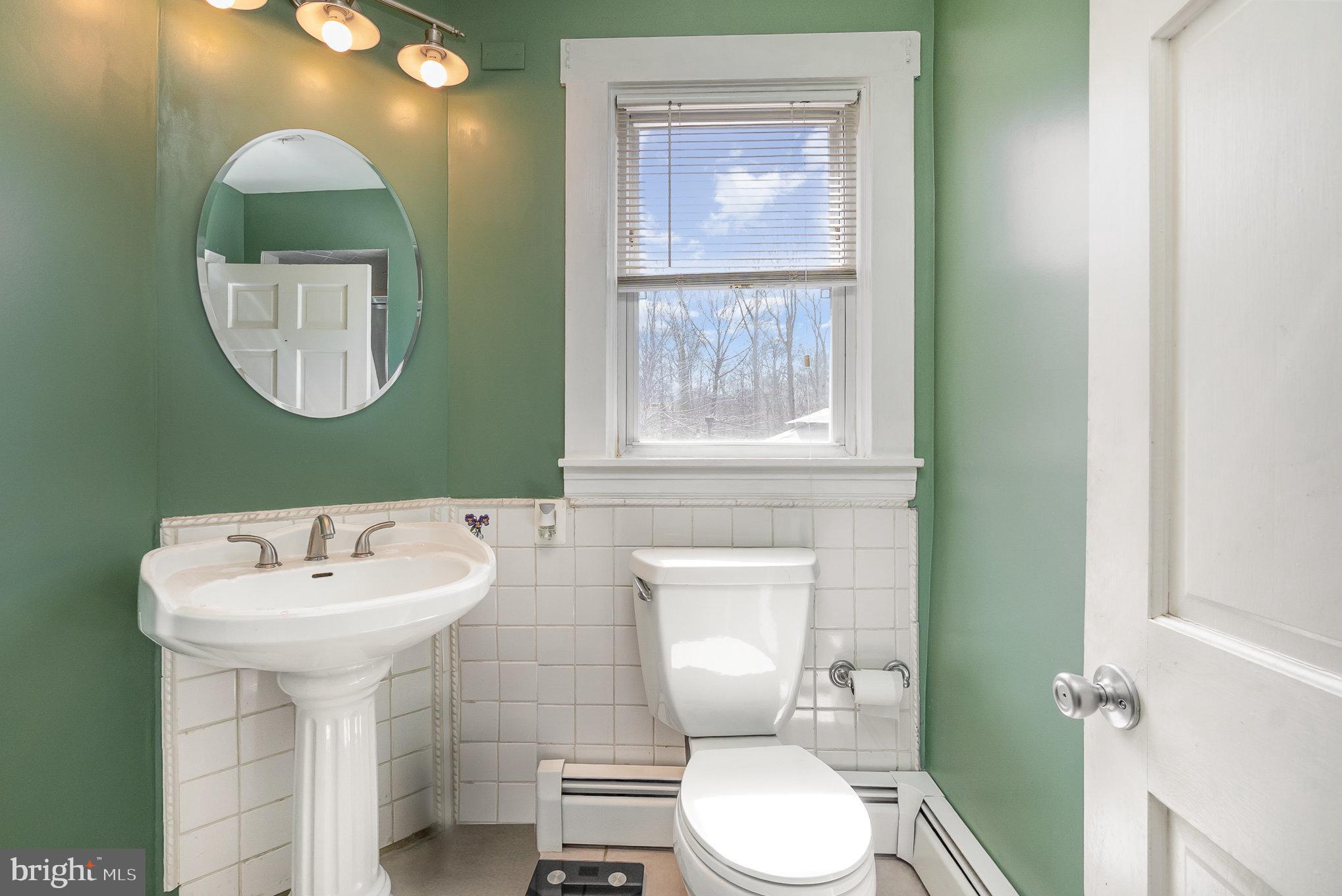 5813 Ebenezer Road White Marsh, MD 21162 - Photo 20 of 46 a bathroom with a toilet sink and mirror