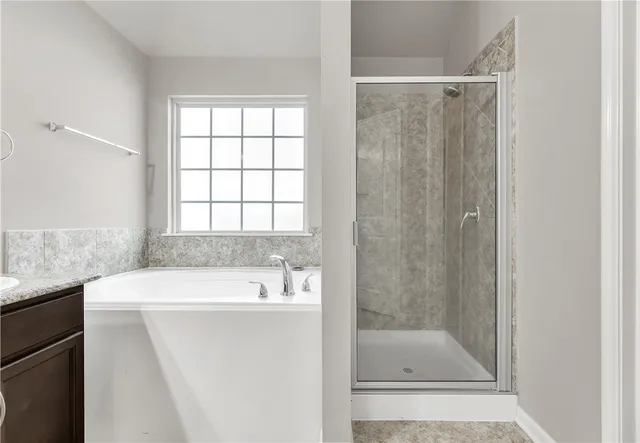 a bathroom with a shower a sink and a bathtub