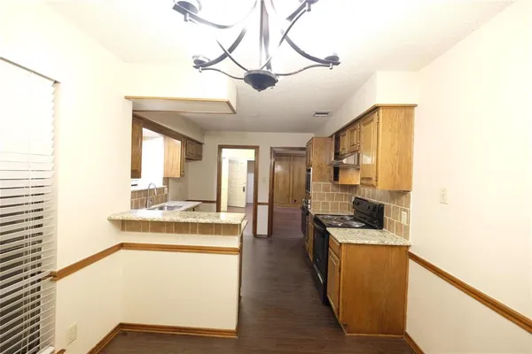 a kitchen with stainless steel appliances granite countertop a stove and a refrigerator