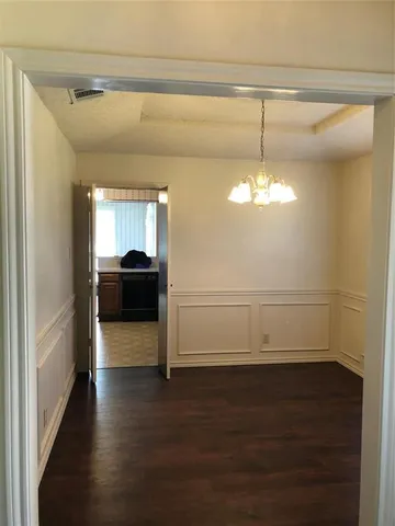 a view of a kitchen with a sink and wooden floor