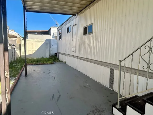 a view of a street with wooden fence