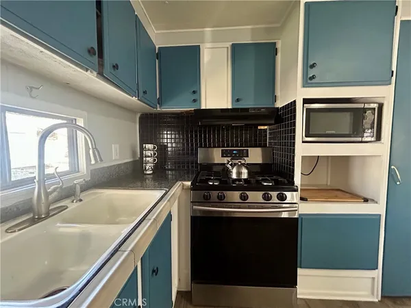 a kitchen with a stove and a microwave