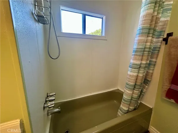 a bathroom with a bathtub and shower