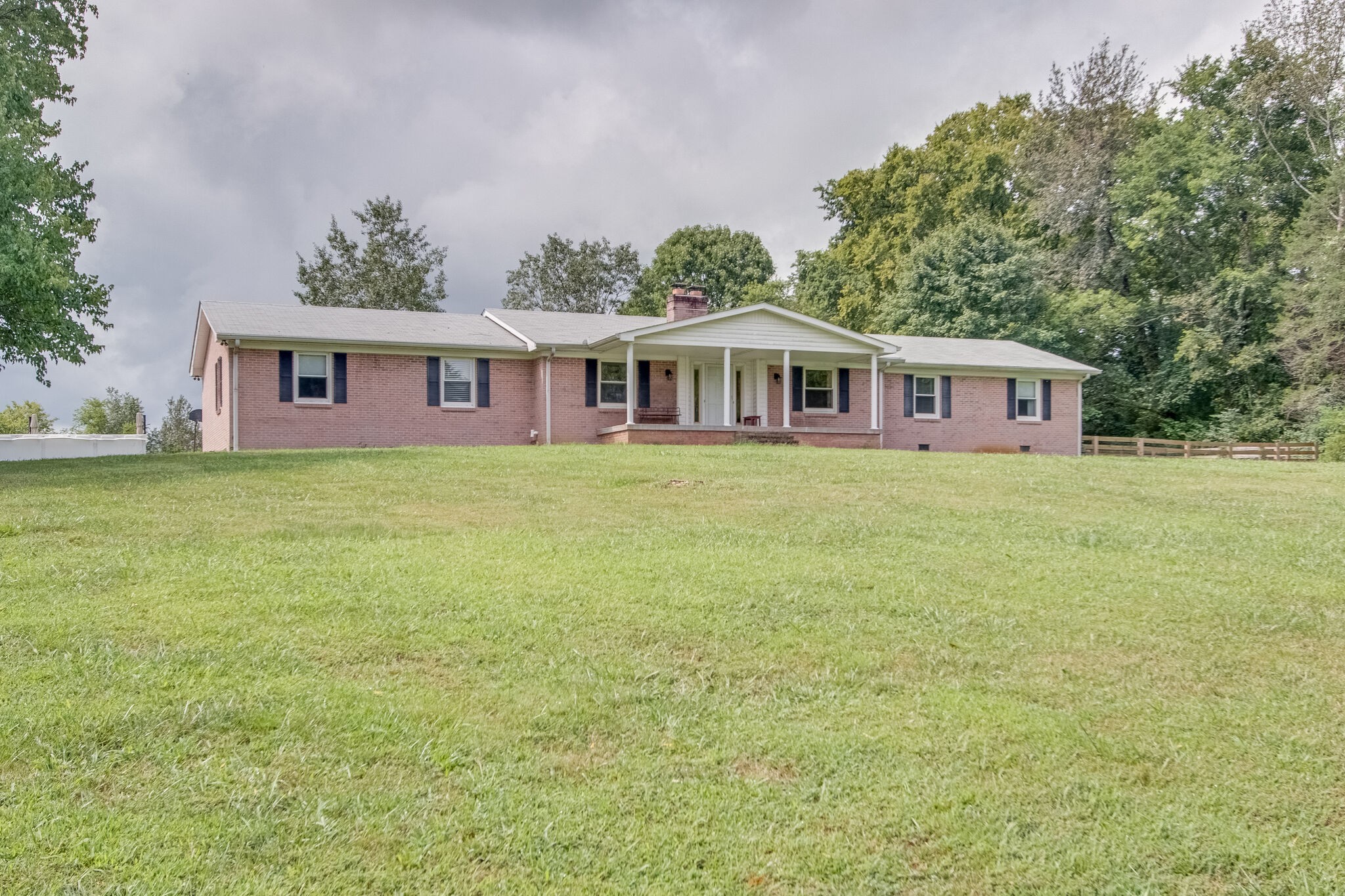 4543 South Carothers Road Franklin, TN 37064 - Photo 1 of 34 a front view of a house with a garden and trees
