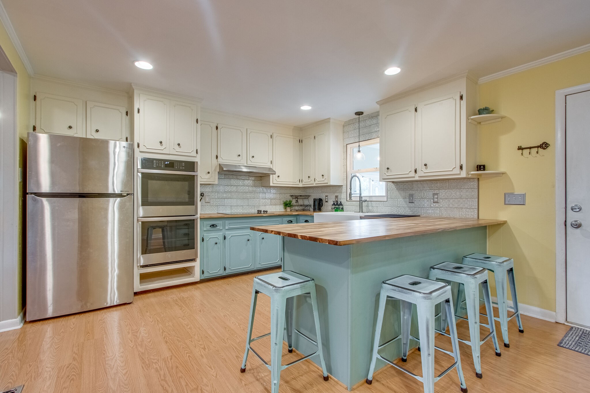 4543 South Carothers Road Franklin, TN 37064 - Photo 6 of 34 a kitchen with stainless steel appliances granite countertop a refrigerator a sink dishwasher a stove and white cabinets with wooden floor