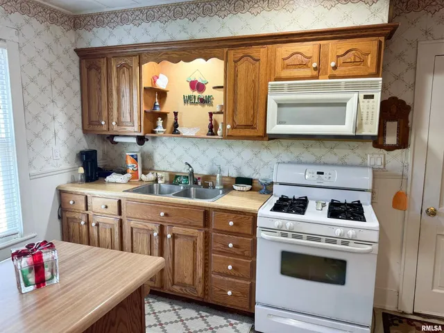 a kitchen with a sink cabinets and appliances