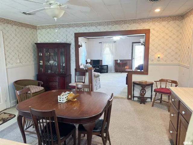 a view of a dining room with furniture and window