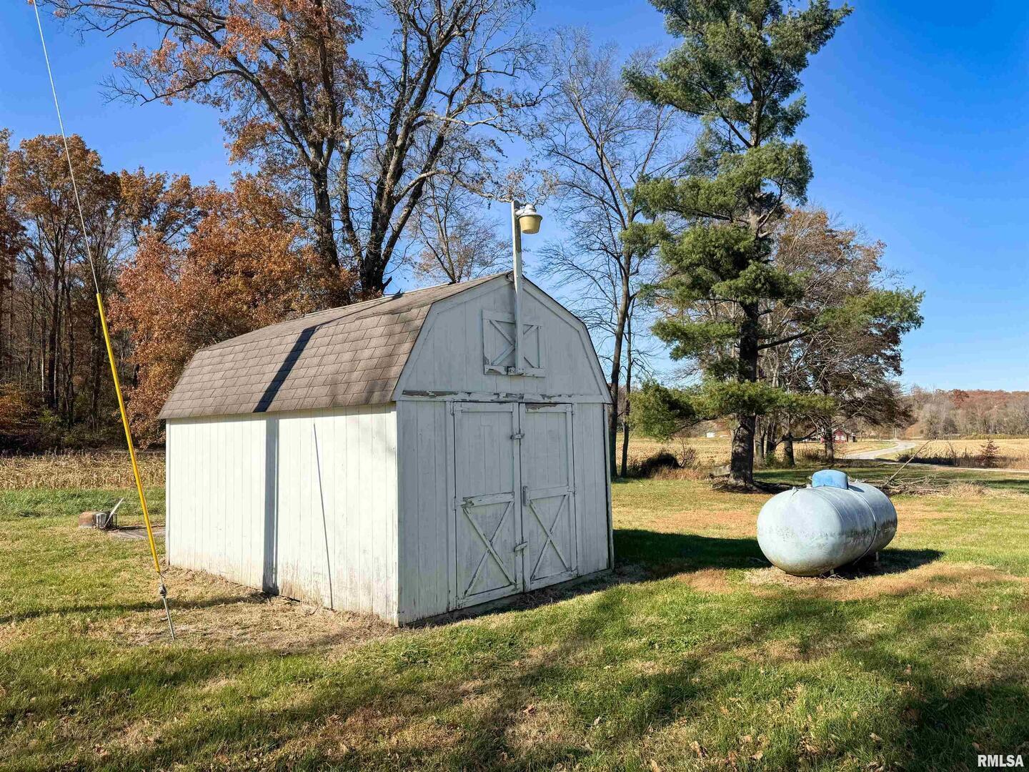1325 Beech Grove Road Wolf Lake, IL 62998 - Photo 10 of 31 a backyard of a house with wooden fence and a tree