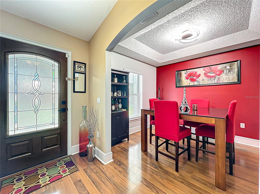 1312 Perkins Road Orlando, FL 32809 - Photo 12 of 80 a view of a dining room with furniture and wooden floor
