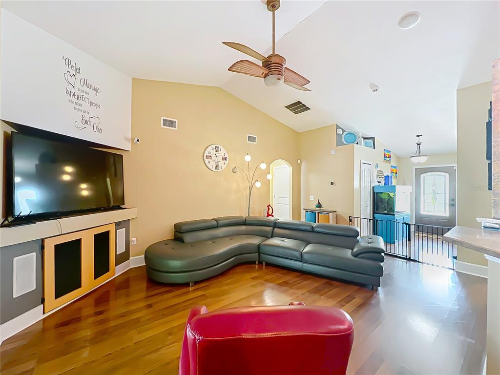 1312 Perkins Road Orlando, FL 32809 - Photo 20 of 80 a living room with furniture and a flat screen tv