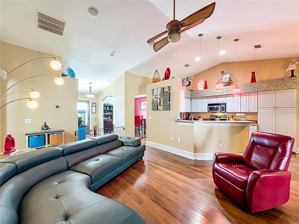 1312 Perkins Road Orlando, FL 32809 - Photo 21 of 80 a living room with furniture and a chandelier