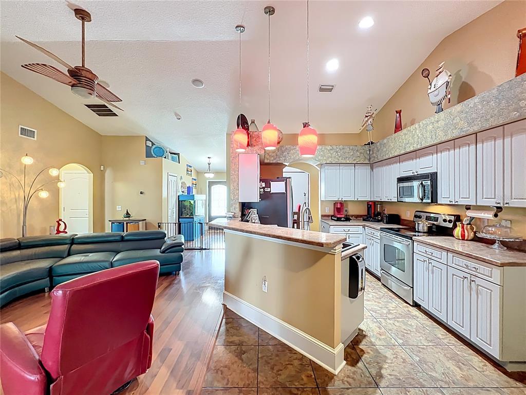 1312 Perkins Road Orlando, FL 32809 - Photo 22 of 80 a kitchen with stainless steel appliances granite countertop a sink stove and refrigerator