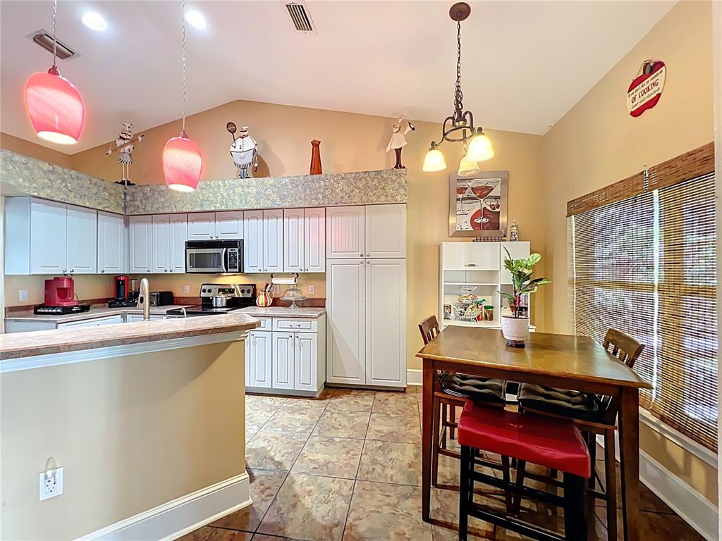 1312 Perkins Road Orlando, FL 32809 - Photo 26 of 80 a kitchen with kitchen island granite countertop a sink cabinets and wooden floor