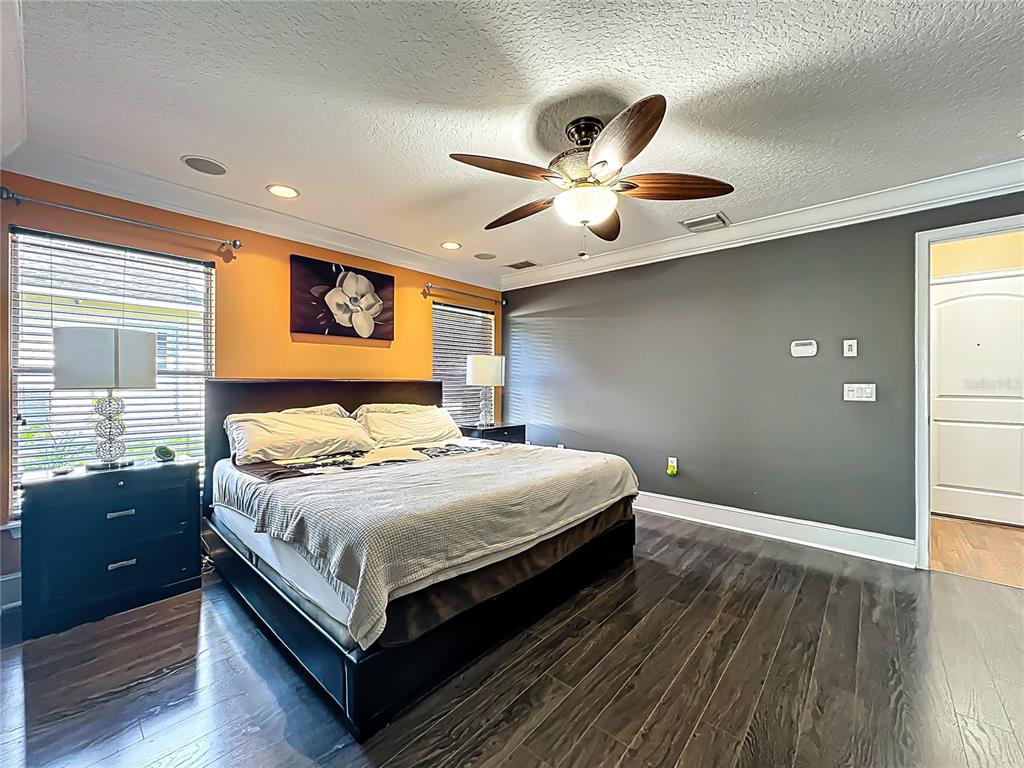 1312 Perkins Road Orlando, FL 32809 - Photo 36 of 80 a bedroom with a large bed and a chandelier