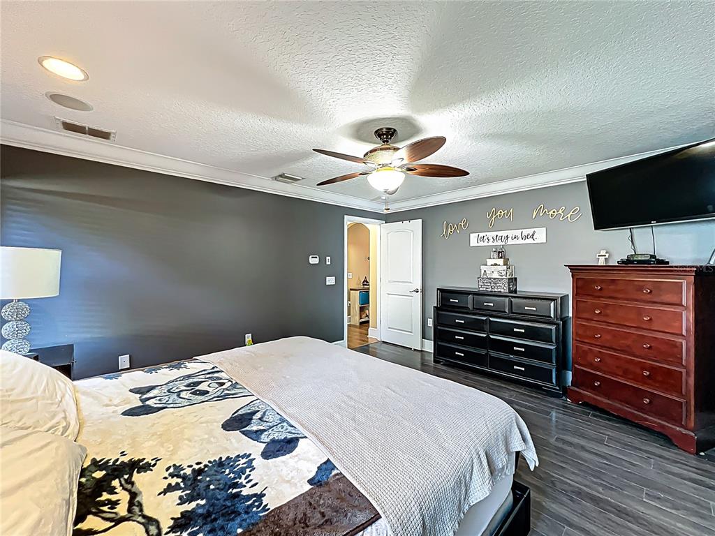 1312 Perkins Road Orlando, FL 32809 - Photo 37 of 80 a bedroom with a bed and a flat screen tv