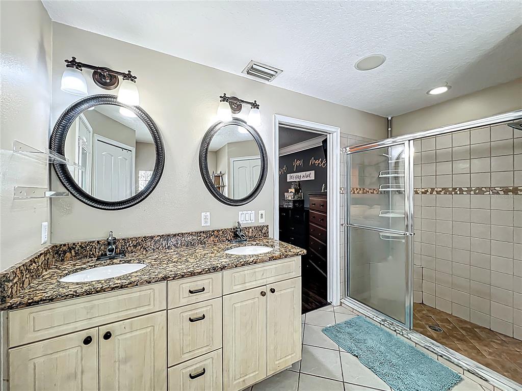 1312 Perkins Road Orlando, FL 32809 - Photo 41 of 80 a bathroom with a granite countertop double vanity sink and a mirror