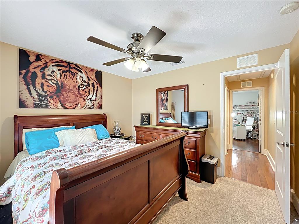 1312 Perkins Road Orlando, FL 32809 - Photo 44 of 80 a bed room with a bed and a chandelier