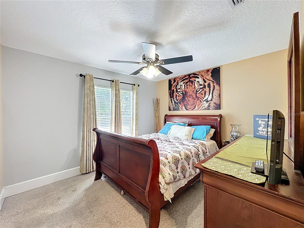 1312 Perkins Road Orlando, FL 32809 - Photo 45 of 80 a bed room with a bed and a chandelier