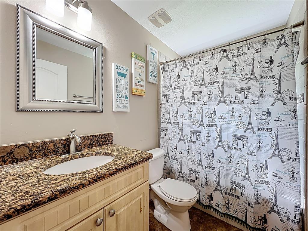 1312 Perkins Road Orlando, FL 32809 - Photo 49 of 80 a bathroom with a granite countertop sink and a mirror