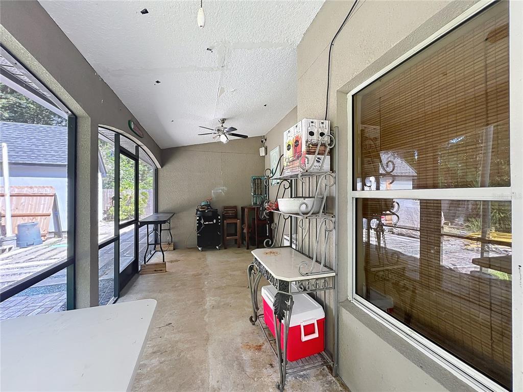 1312 Perkins Road Orlando, FL 32809 - Photo 50 of 80 a living room with furniture a flat screen tv and a floor to ceiling window